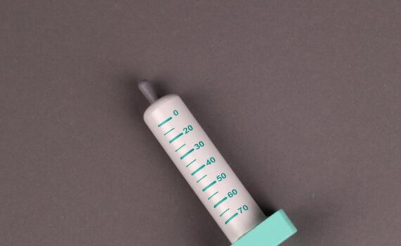 children toy syringe on grey background