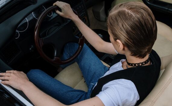 a woman driving a convertible car