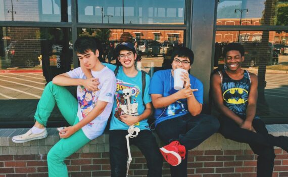 four men sitting on platform