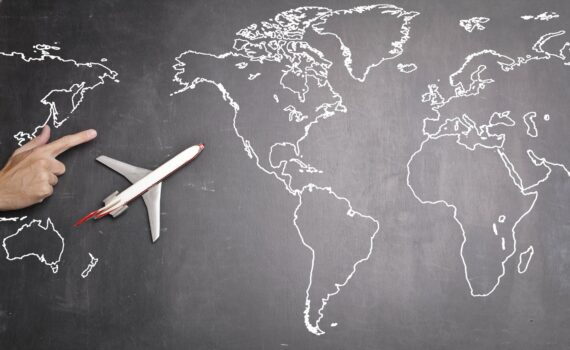 airplane over world map on blackboard