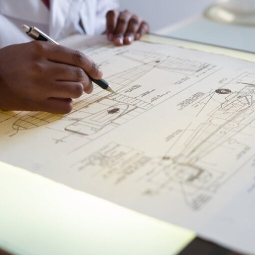 faceless engineer adding details to sketch of aircraft