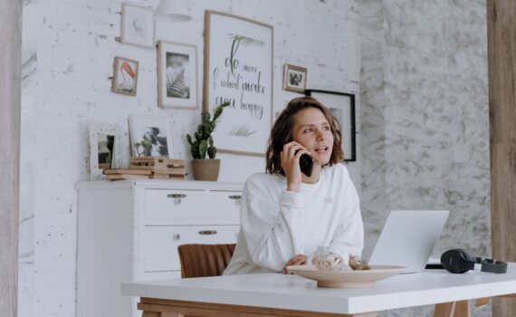 woman in white robe sitting on brown wooden chair