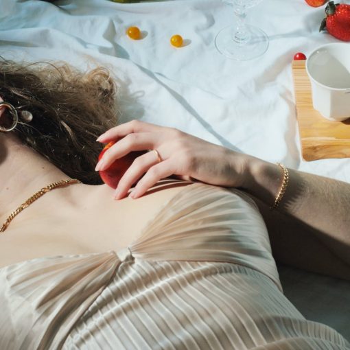 relaxed woman with fruit lying on blanket