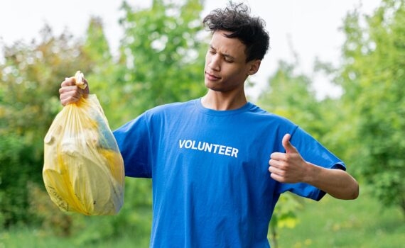 a man holding a bag of plastics