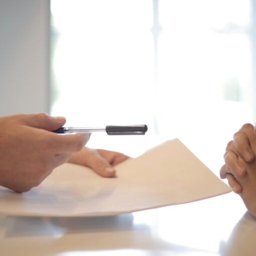businessman giving contract to woman to sign