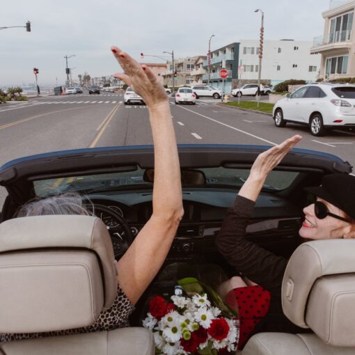 two people riding in convertible car
