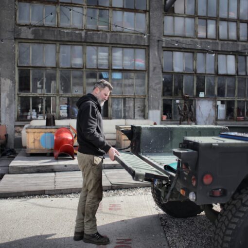 male worker near pickup truck in industrial area