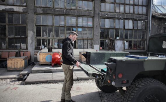 male worker near pickup truck in industrial area