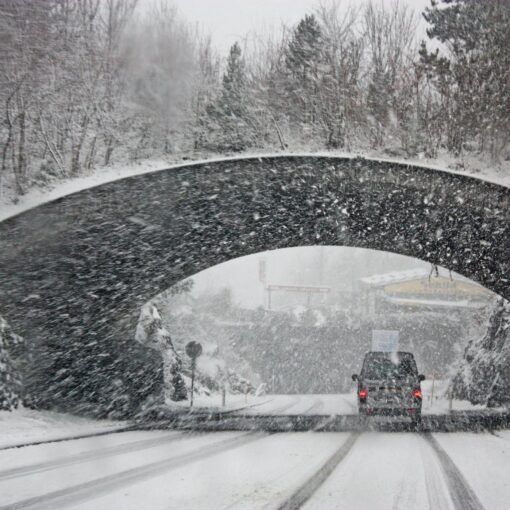 photo of white vehicle crossing a tunnel
