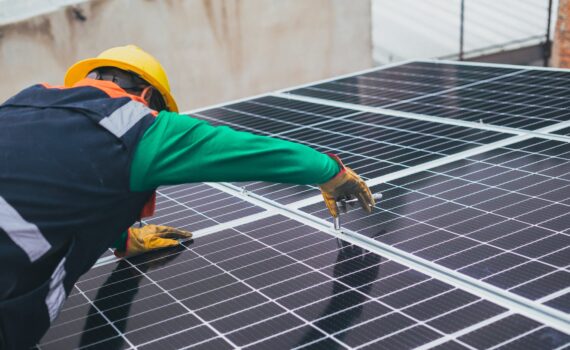 solar technician installing solar panel