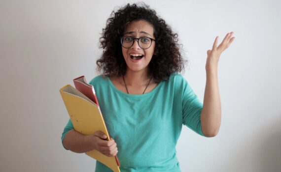 adult displeased businesswoman with papers in light modern office