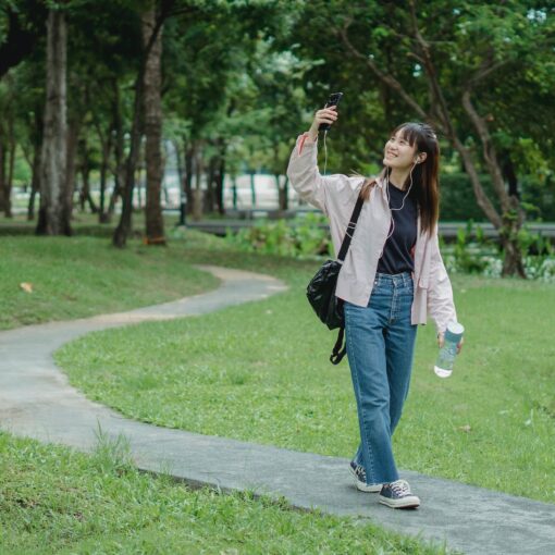 smiling woman taking selfie in park