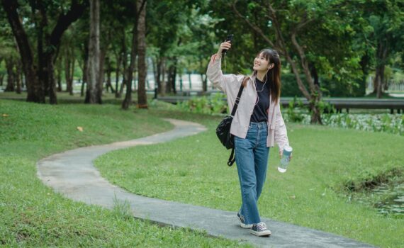 smiling woman taking selfie in park
