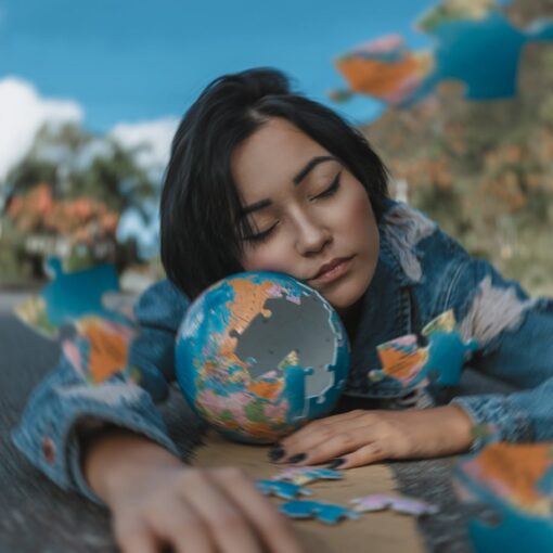 woman in blue and white floral long sleeve shirt holding a round shaped puzzle