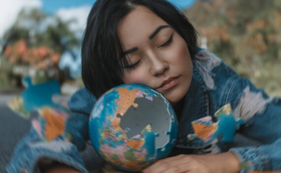 woman in blue and white floral long sleeve shirt holding a round shaped puzzle