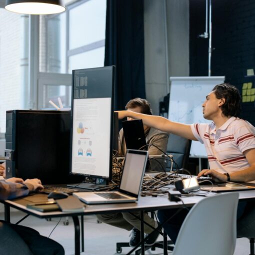 people sitting at the table with computers