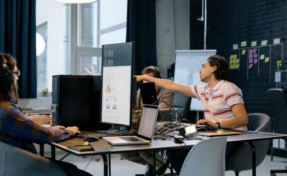 people sitting at the table with computers